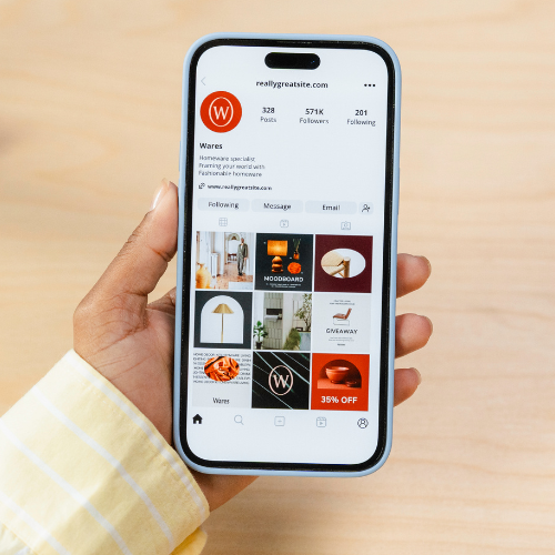 Hand holding a smartphone displaying an Instagram business profile for a homeware brand – social media marketing and content strategy example